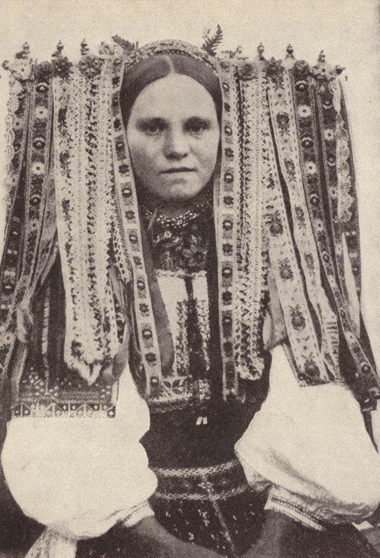 Czech woman wearing a headdress of ribbons where each ribbon denotes a suitor she refused in marriage by Photographer Czech