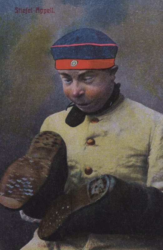 German soldier looking at the soles of his boots by Photographer German
