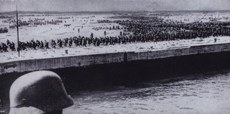German soldier surveying Allied prisoners on the beach at Dunkirk, France, World War II, June 1940 by Photographer German