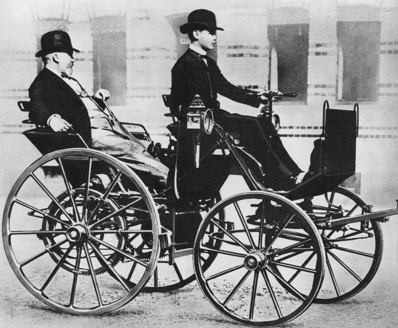 Gottlieb Daimler, with his son driving, in the first motor car by Photographer German