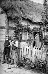 Two men chatting outside a cottage, near Lucton, Herefordshire, c. 1922