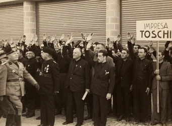 The construction workers of the Company Mauro Toschi fu Ulisse, salute the Duce Benito Mussolini during Inauguration of the buildings of the Royal Airport 
