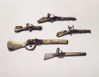 Gold weights cast in the form of guns