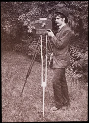 Self portrait with camera, tripod and pistol