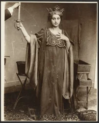 Female Model Wearing Crown and Holding Sword