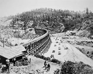 Chinese labourers working on a trestle bridge on the western slope of the Sierra Nevada mountains