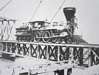 Locomotive of the US Military Railroads (Union Army) crossing trestle bridge over the Potomac River