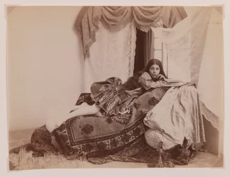 Studio shot of a reclining lady reading a book