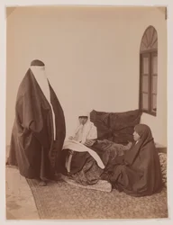 Two veiled women and a child