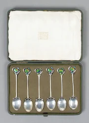 A Boxed Set of Cymric Silver Spoons with Enamelled Finials Designed by Archibald Knox