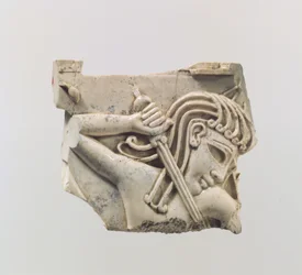 Cloisonné furniture plaque with a figure holding a sword, c.9th–8th century BC