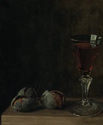 A Glass of Wine with Walnuts on a Table