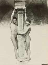 [Two Boys Holding onto a Column]