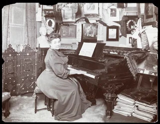 Madame Schumann Heink seated at a piano