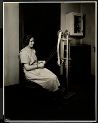 Portrait of a blind, deaf and dumb young woman spinning wool at the New York Association for the Blind, 111 East 59th St., New York, 1923