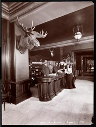 The lobby and registration desk at the Park Avenue Hotel, 1901 or 1902
