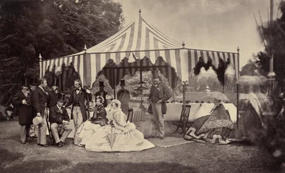 Group of Well-Dressed People in Front of an Outdoor Tent