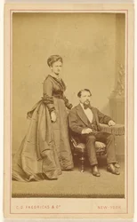 Unidentified Couple: Woman Standing, Man with Vandyke Beard Seated