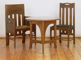 An armchair, made for the Luncheon Room, and dining chair, 1897, from Miss Cranstons Argyle Street Tea Rooms, Glasgow, and an occasional table made for the Billiards Room at Miss Cranstons Buchanan St