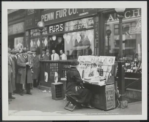 Blind news dealer, Fannie Lyons, at her stand at the southeast corner of 7th Avenue & 34th Street