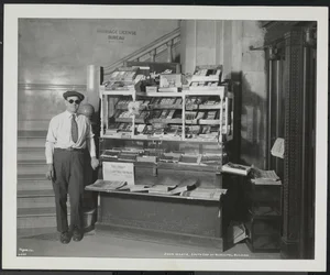 Blind news dealer, John Martie, at his stand at the south end of the Municipal Building, New York