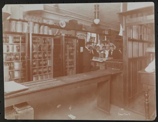 Retail area at the Empire Film Co (possibly at Broadway and 55th Street) with canisters of film, New York