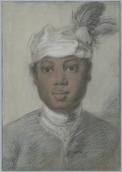 Head of a young Black man wearing a turban with feathers