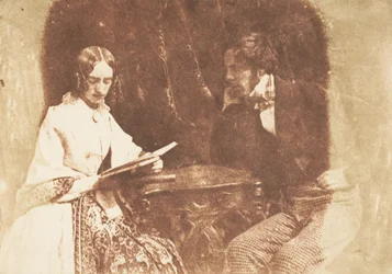 Couple Seated, Woman Reading