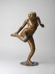 Dancer looking at the sole of her right foot