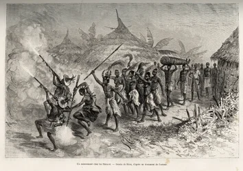 A funeral at the Siene-re (Siene Re), in Fourou (Mali), the funebre cortege crosses the village, led by the armed men of the deceased