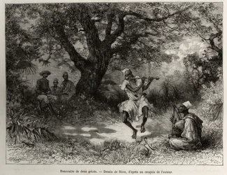 Meeting two griots: Captain Binger, sitting in the shade, enjoys the performance. Engraving by Riou, illustrating the story „From Niger to the Gulf of Guinea“ by Captain Louis Gustave Binger (1856-1936), 1887-1889, in Le Tour du monde, nouveau journal des