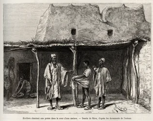 Muslim schoolchildren singing a prayer in the courtyard of a house, practiced in the country of Kong (Niger), the schoolchildren receive a handful of cauris, which they hand over to their teacher and which corresponds to a kind of tax for public education