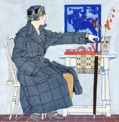 A young woman sitting beside a table holding an umbrella