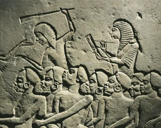 Negroid prisoners surrounded by guards armed with clubs while a scribe draws up a report (detail)