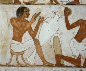 Vasemakers decorating a vase