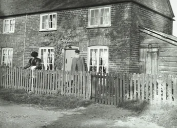 A Rural Scene in the Wandsworth Area with an Elderly Couple in the Garden of a Cottage-Style Property, London, 1895