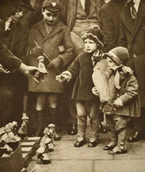 Children crowding round a street hawker, Holborn