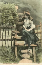 Couple embracing on a country stile