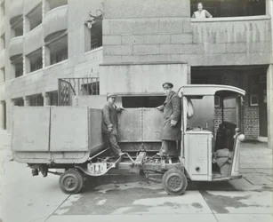 Ossulston Estate: dustmen empty container at the bottom of the rubbish chute