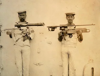 Two Sailors, from the HMS Glory, holding guns