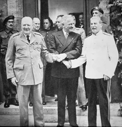 Winston Churchill, President Truman, and Joseph Stalin shaking hands at the Potsdam Conference, July 1945