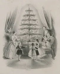 A Family Standing Around a Christmas Tree