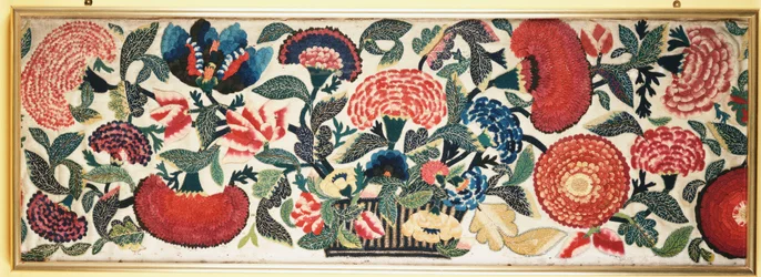 A Felt and Applique Panel with Embroidered Silk Highlights Depicting Carnations, Tulips & Other Flowers Overflowing from a Basket Against an Ivory Wool Ground