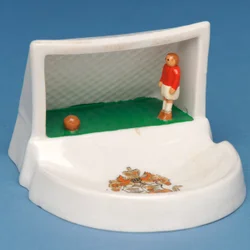 Rare armorial souvenir of Douglas, Isle of Man, showing a goalkeeper in his goal (ceramic)