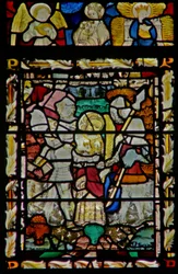 The east window depicting the arrest of St John, angel musician, Virgin & Child, and another Virgin in the canopy