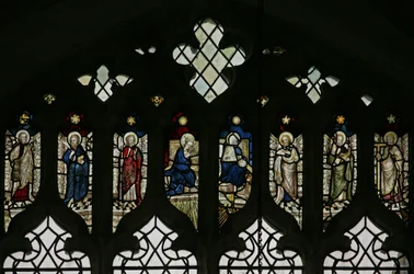 Window N5 depicting the tracery lights with an array of saints that include Philip, Bartholomew, Mathias, Simon, Jude and Thomas with the Coronation of the Virgin at the centre