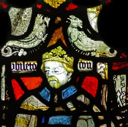Window depicting a composite figure of a king and an archbishop; grotesques