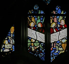 Window depicting the angelic choir singing; angel censing