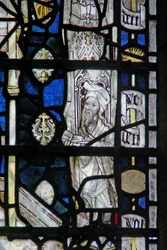 Window depicting a border panel with a figure