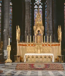High Altar in neo-gothic style, surrounded by 4 angels carrying the instruments of the Passion of Christ with a tabernacle surmounted by an elaborately decorated spire